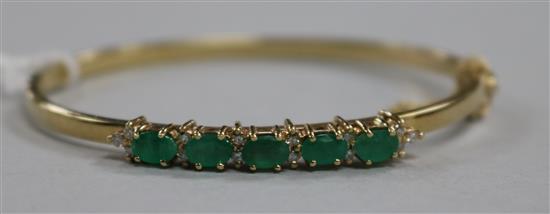 A 9ct gold, emerald and diamond hinged bangle,